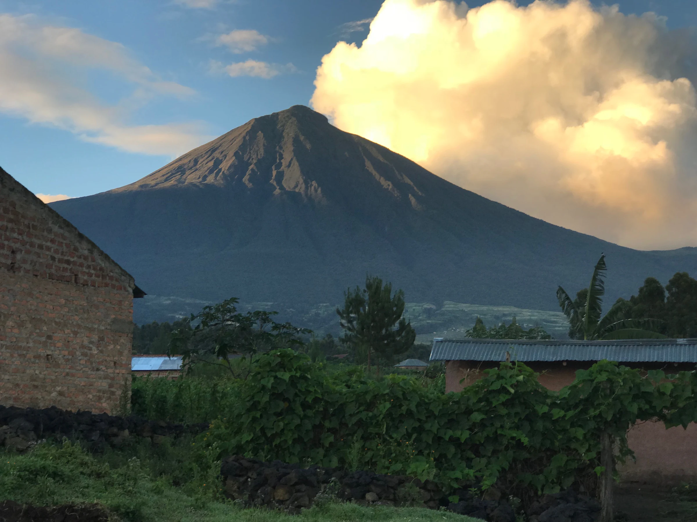 Cloud gathering around a volcanic peak in Volcanoes National Park, Rwanda